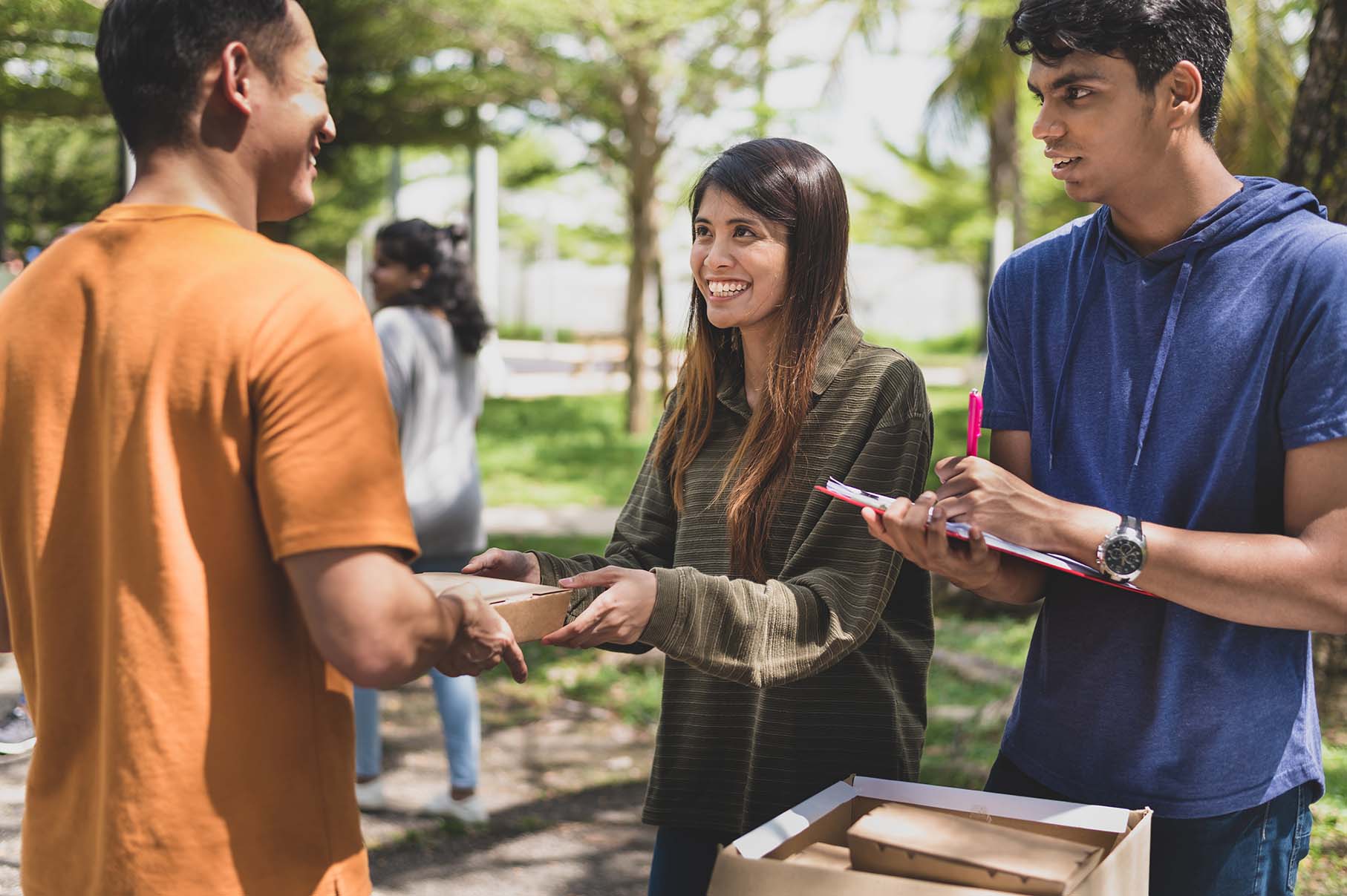 Photo of three people involved in a community event.