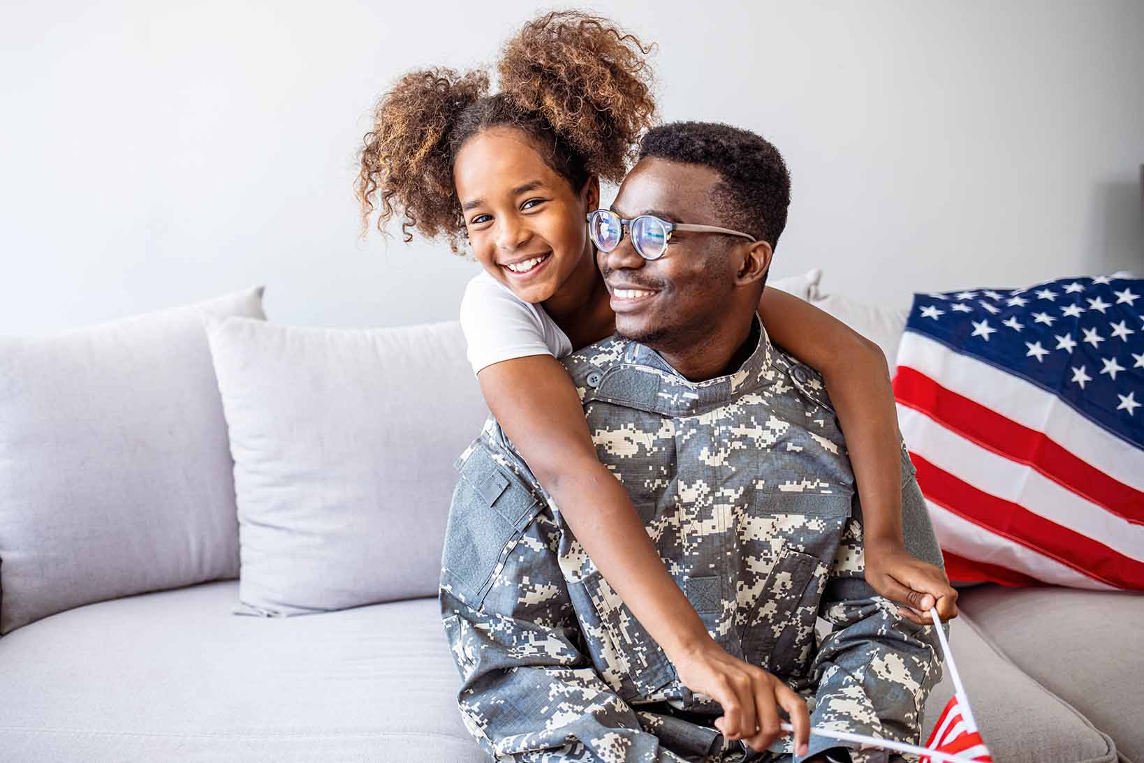 Father and daughter hugging, father in military uniform