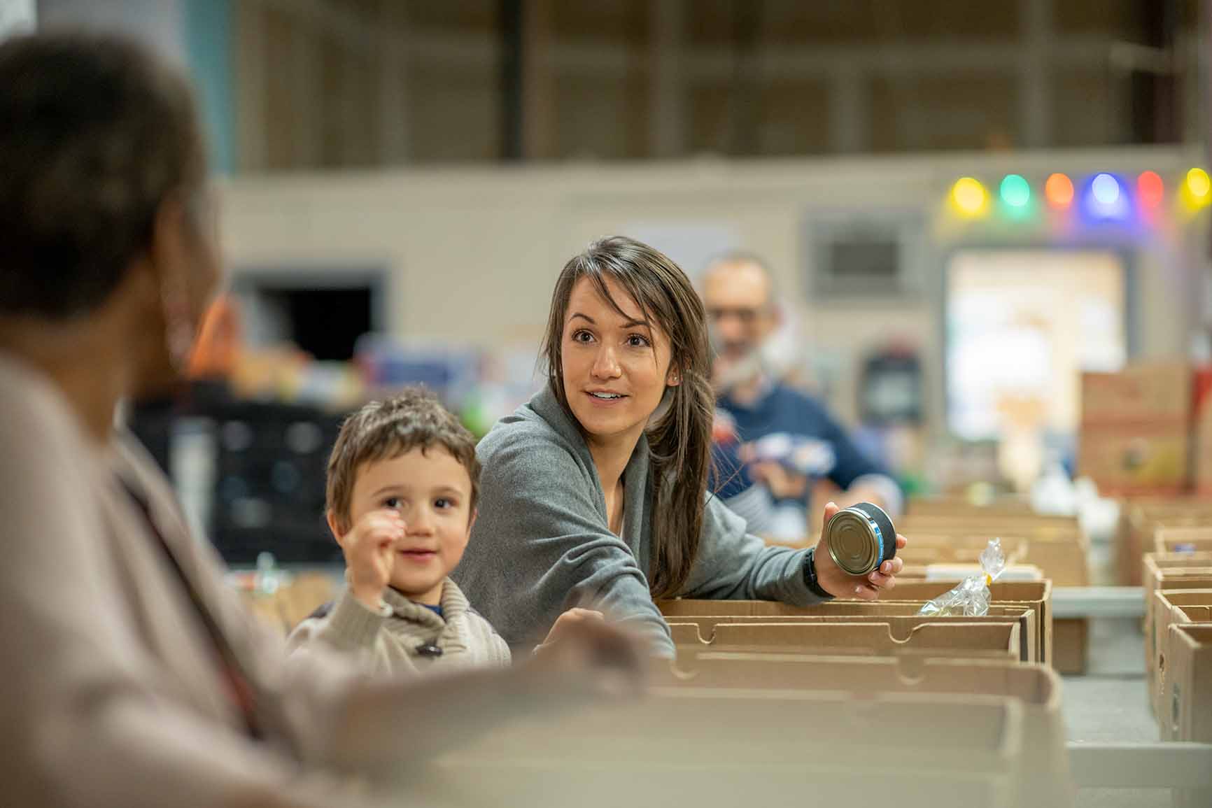 Mother and son packing items at a food pantry